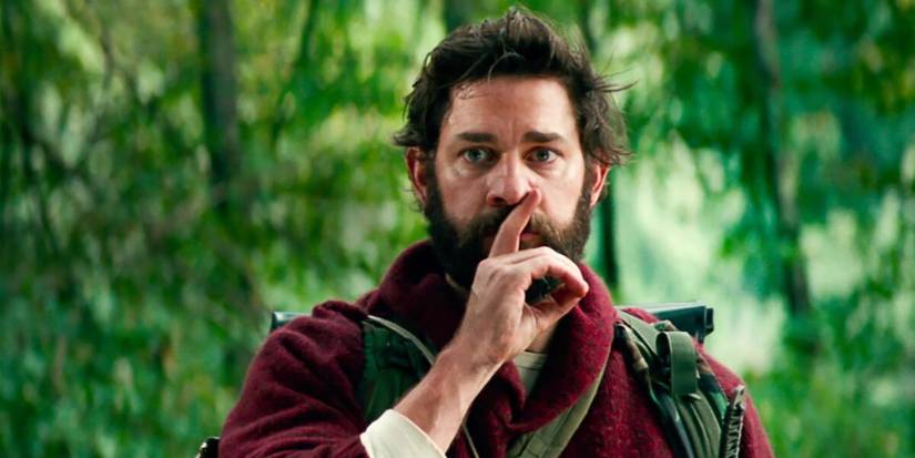 John Krasinski as Lee Abbott, holding a finger to his lips in A Quiet Place.