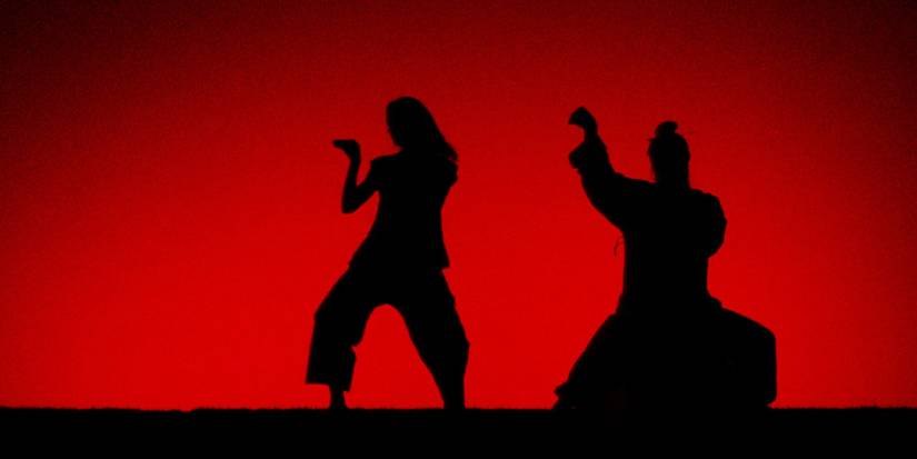 Uma Thurman as the Bride, training with Pai Mei in shadow amidst a red background