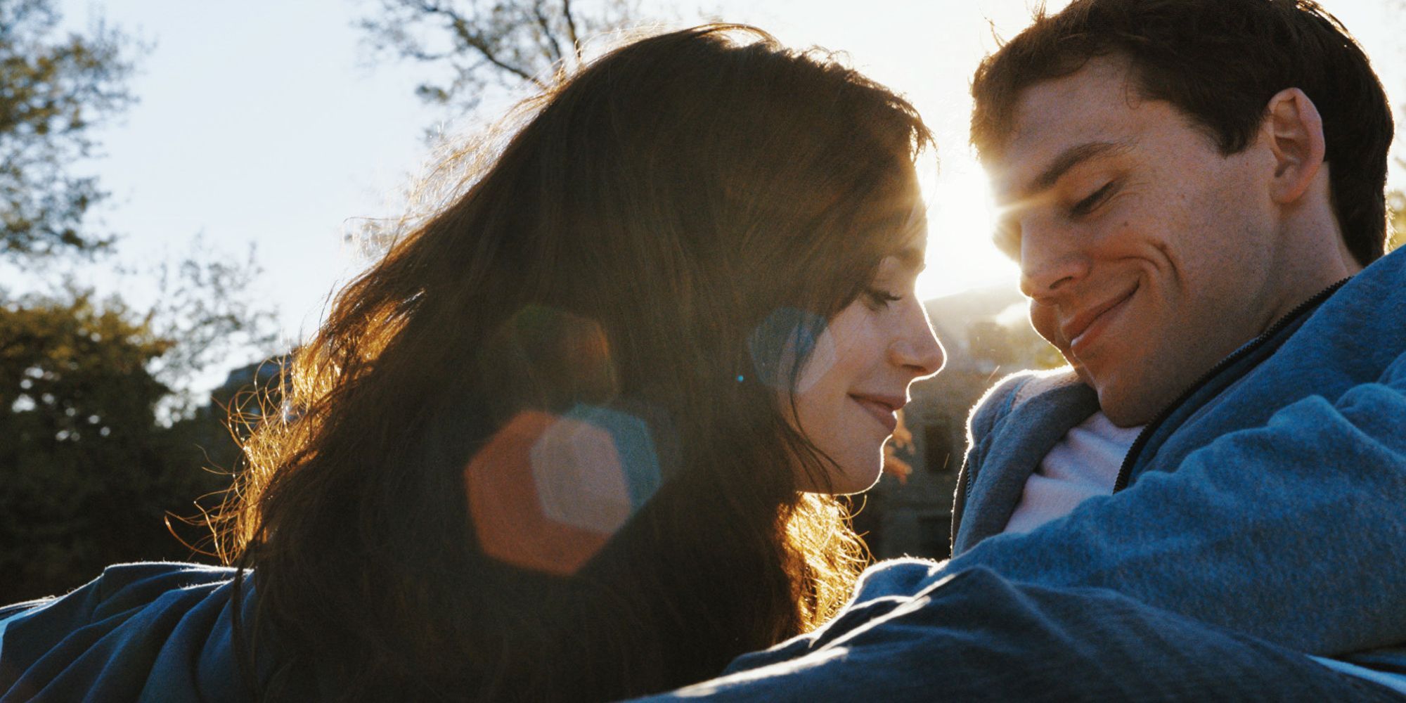 Lily Collins & Sam Claflin cuddling in the grass in Love, Rosie