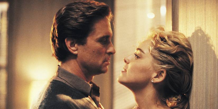 Michael Douglas as Nick and Sharon Stone as Catherine stare at each other against a wall in Basic Instinct.