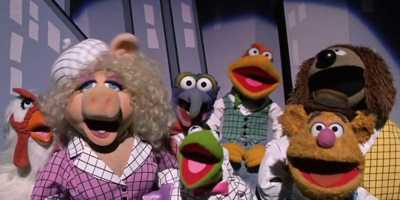 Miss Piggy, Kermit, Fozzie, Gonzo, Camilla, Rowlf, and Scooter singing in 'The Muppets Take Manhattan'