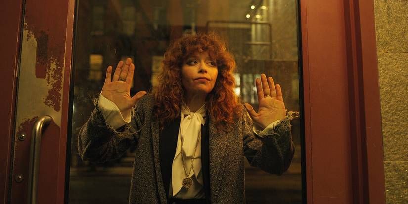 Natasha Lyonne with her hands up against the glass doors of a subway in Russian Doll.