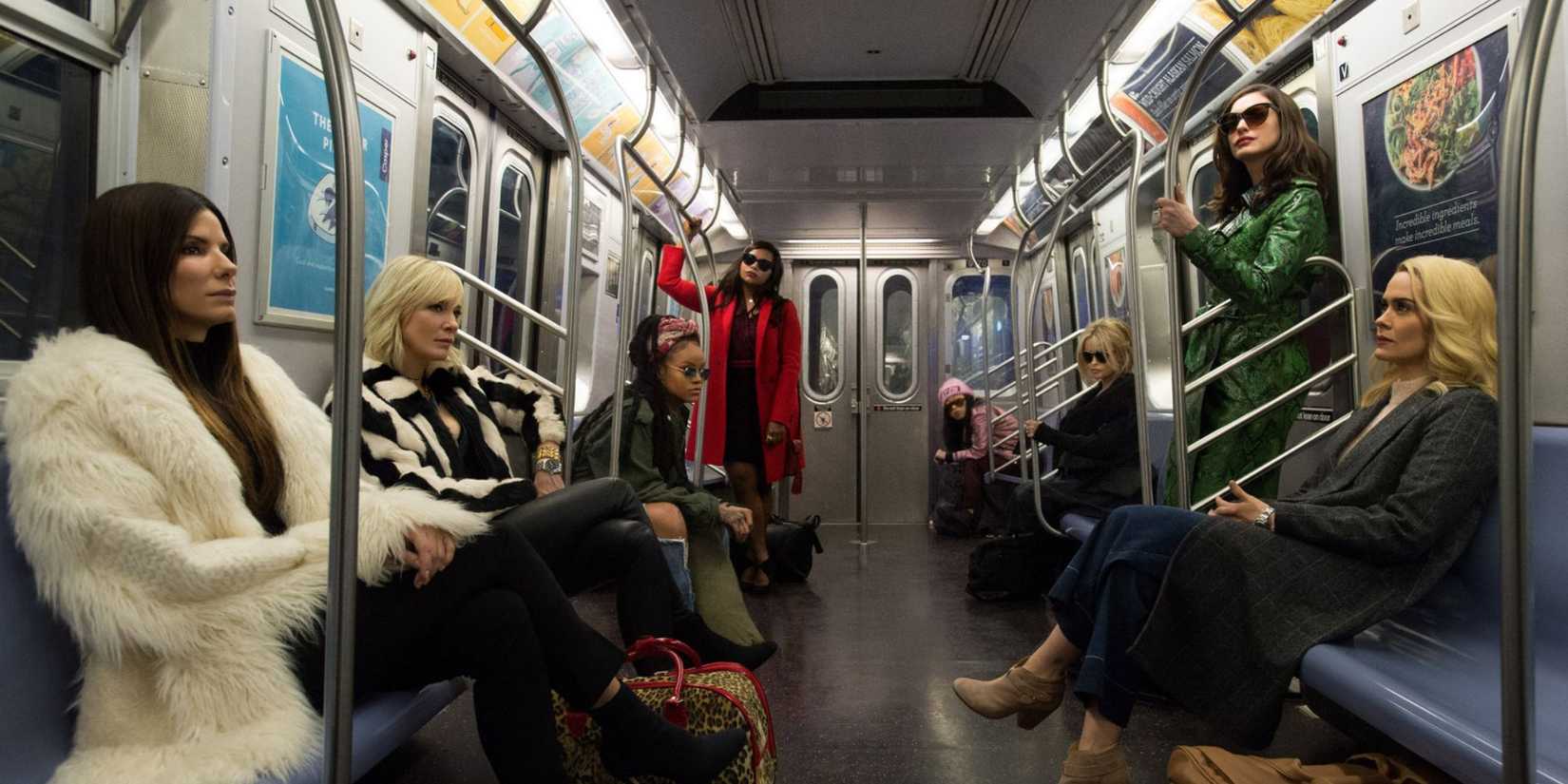 Cast of Ocean's 8 sitting on the subway 