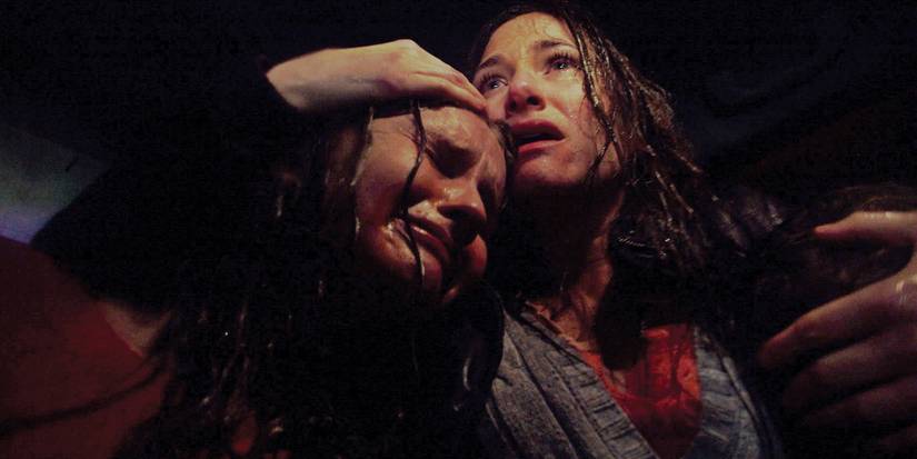 Olivia DeJonge and Kathryn Hahn hug after a terrifying ordeal in The Visit