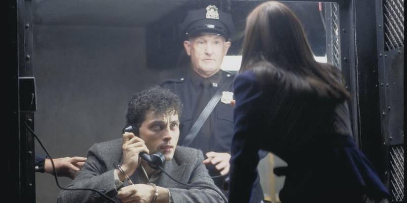 Rufus Sewell as John Murduch talking to someone through a prison phone in Dark City