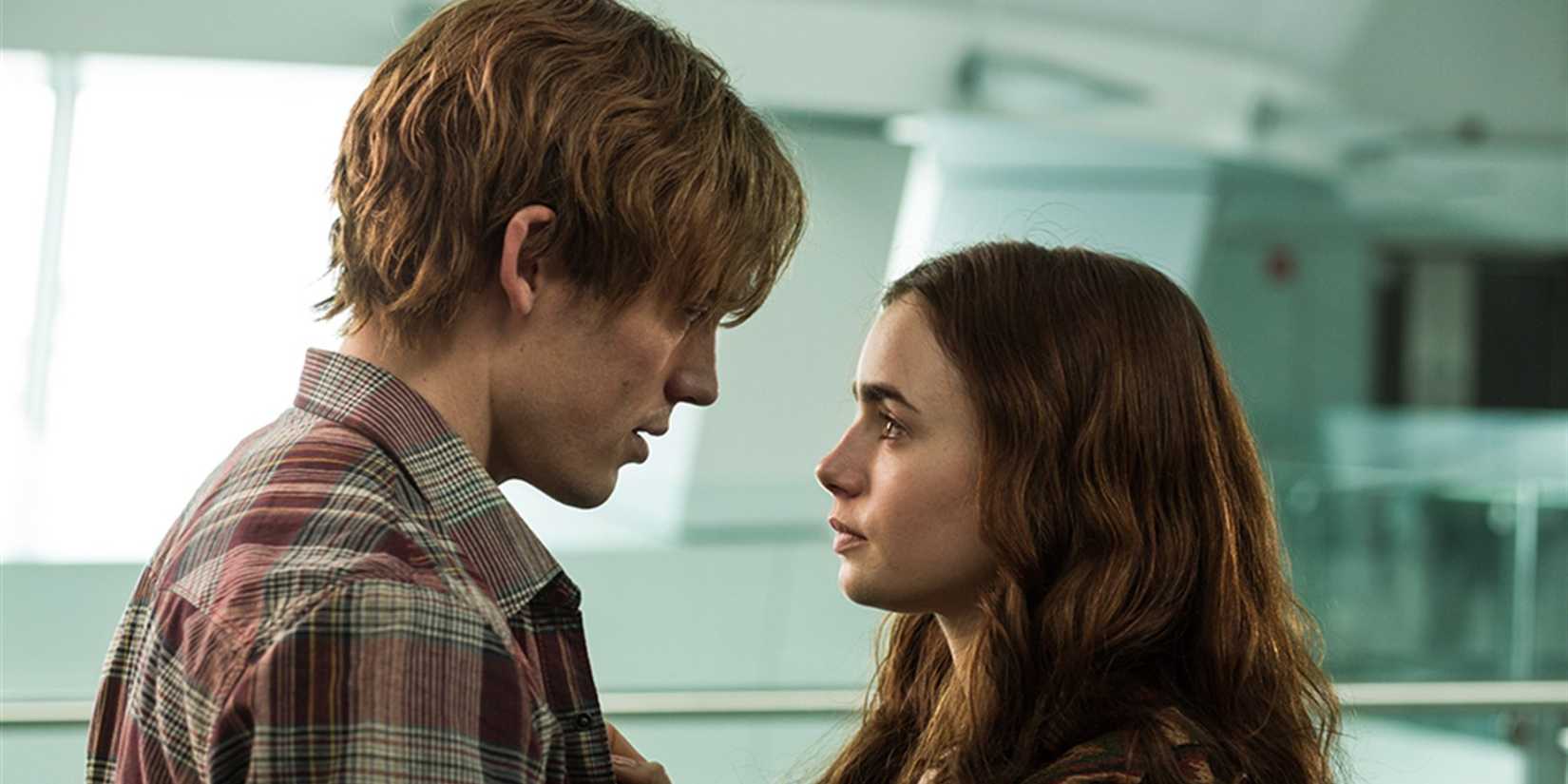 Sam Claflin and Lily Collins looking at each other in 'Love, Rosie'