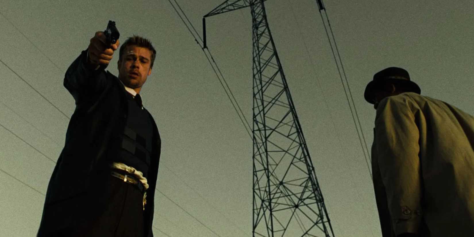 David Mills looks down with an expression of pain while William Somerset looks away in Se7en (1995)