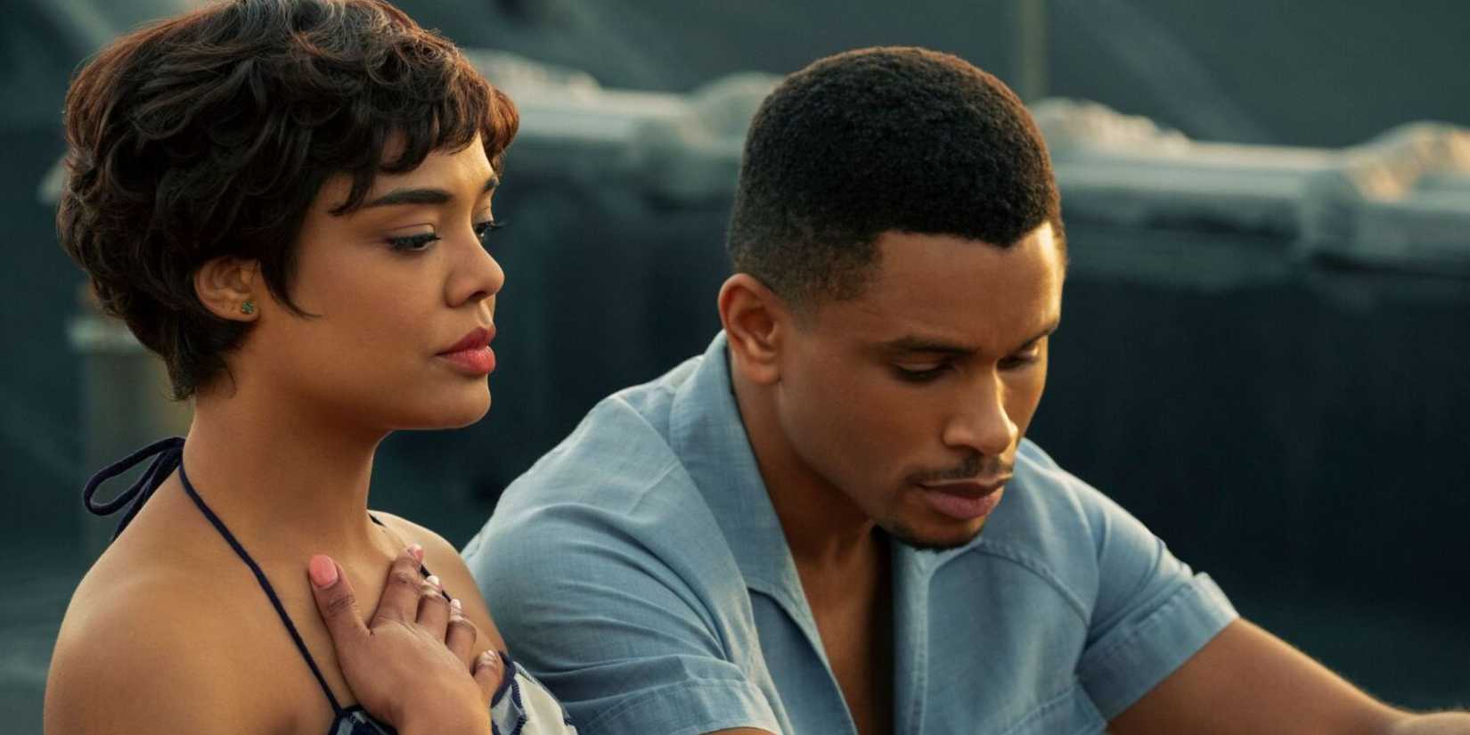 Tessa Thompson next to a costar as they sit outside and look serious in Sylvie's Love.