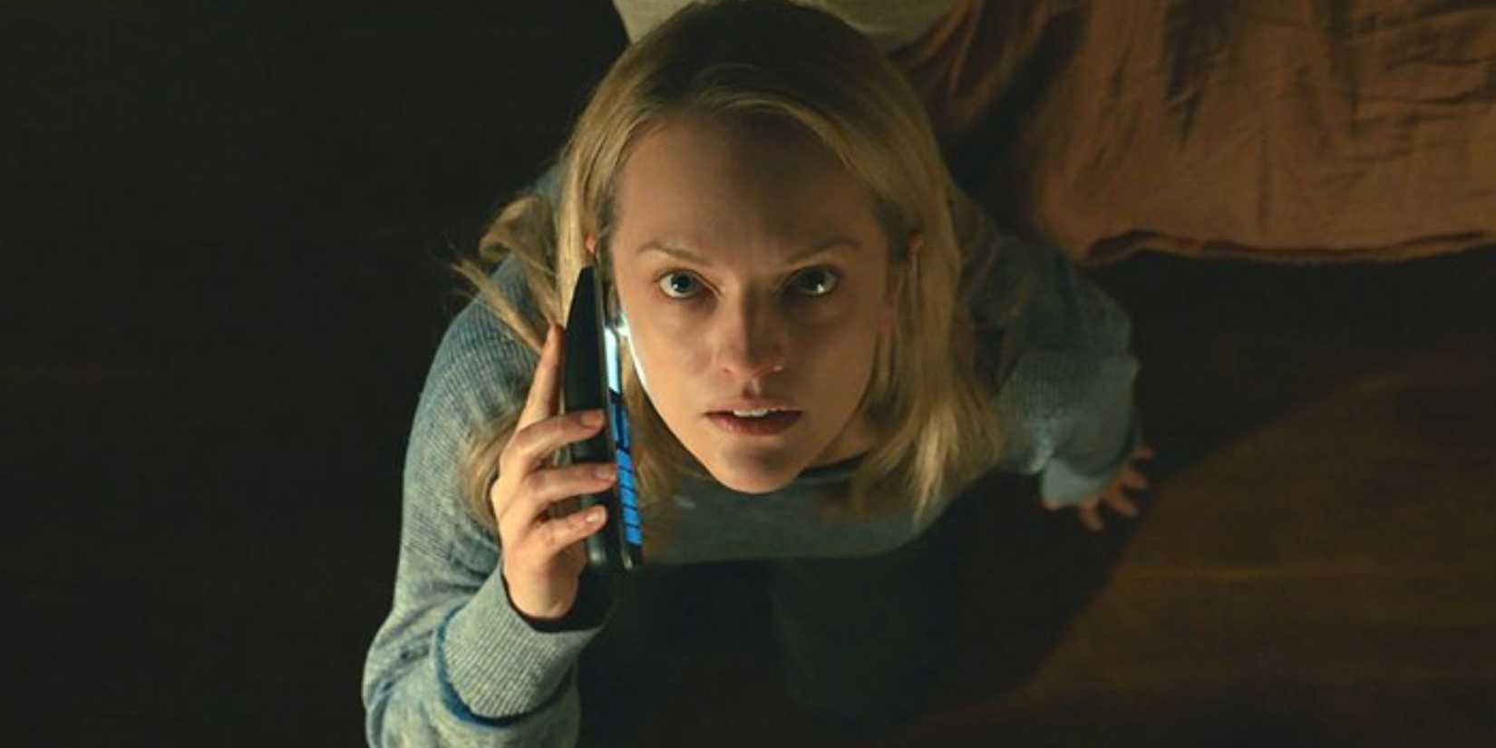 Cecilia (Elisabeth Moss) is on the phone while looking up in 'The Invisible Man' (2020)