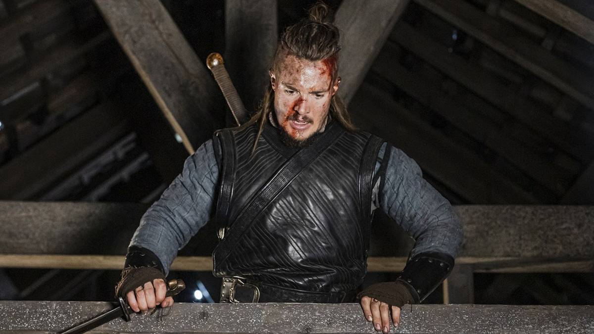 Alexander Dreymon covered in blood and standing in the rafters in The Last Kingdom.