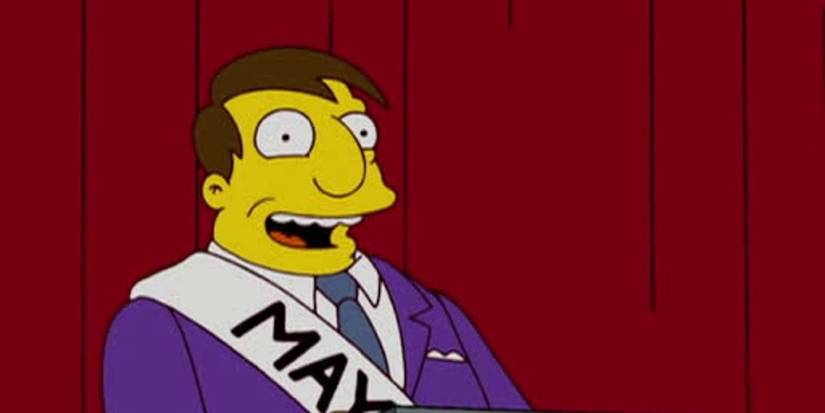 Mayor Quimby, voiced by Dan Castellaneta, on stage smiling in The Simpsons.