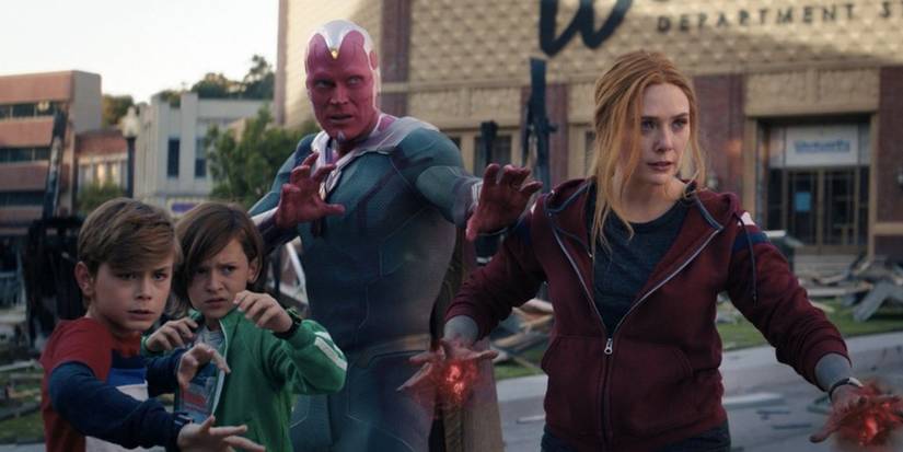 Wanda, Vision, Billy, and Tommy stand in the street ready to fight something in WandaVision.