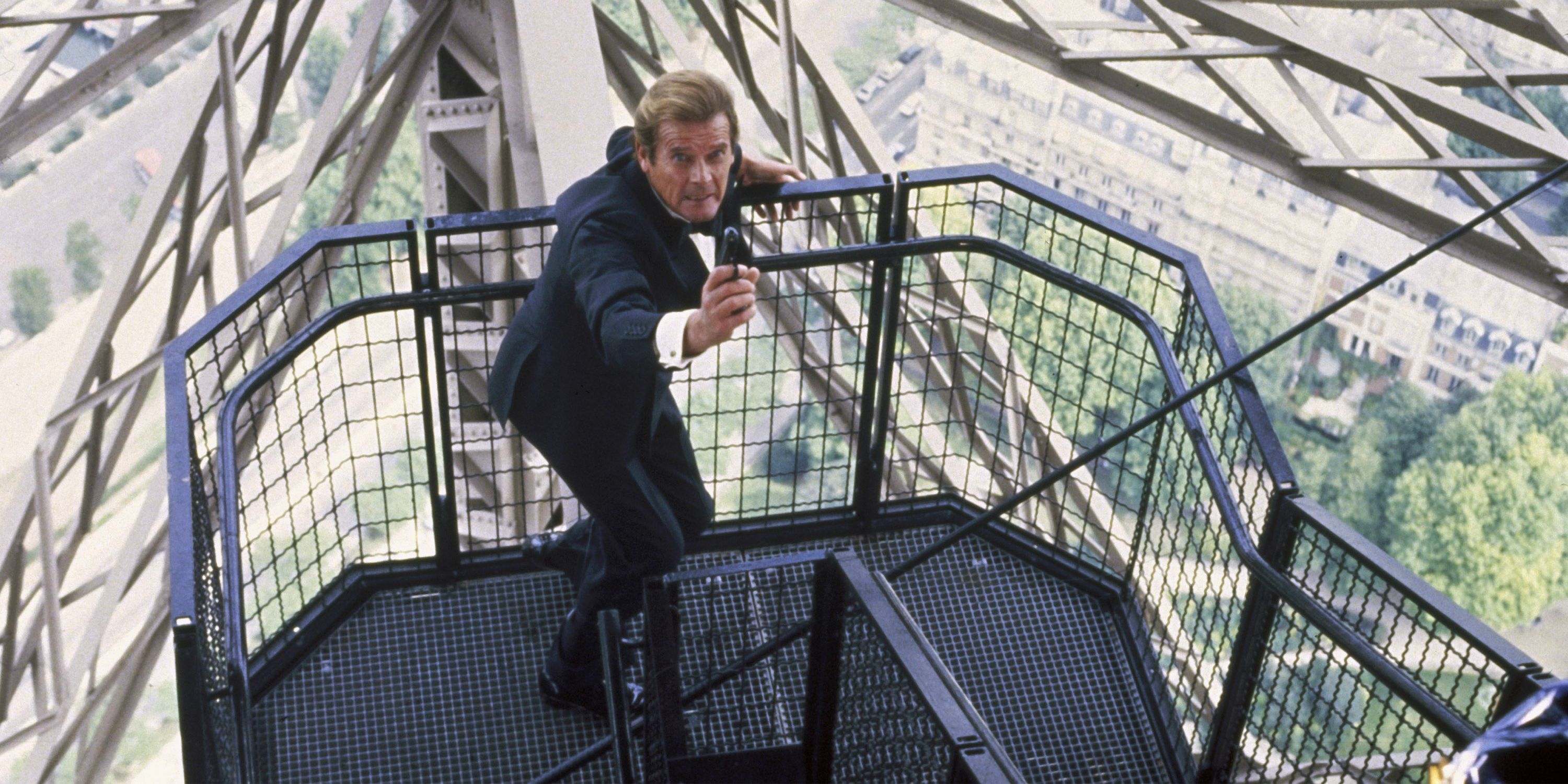 British Agent 007 aims his weapon as he climbs a perilously high flight of stairs.