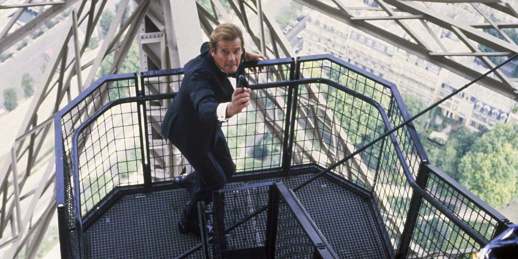 James Bond aims his weapon as he climbs a perilously high flight of stairs in A View to Kill