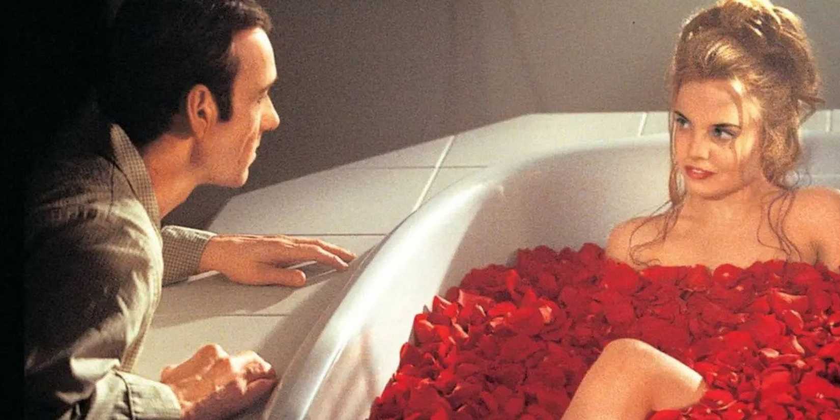 Kevin Spacey looking at Mena Suvari sitting in a bathtub of rose petals in 'American Beauty'