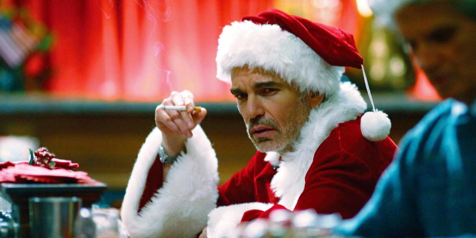 Billy Bob Thornton smoking a cigarette in a Santa costume in Bad Santa.