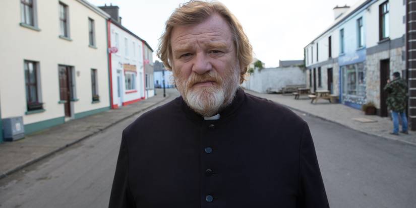 Father James (Brendan Gleeson) looking distressed while walking down a street in 'Calvary.'