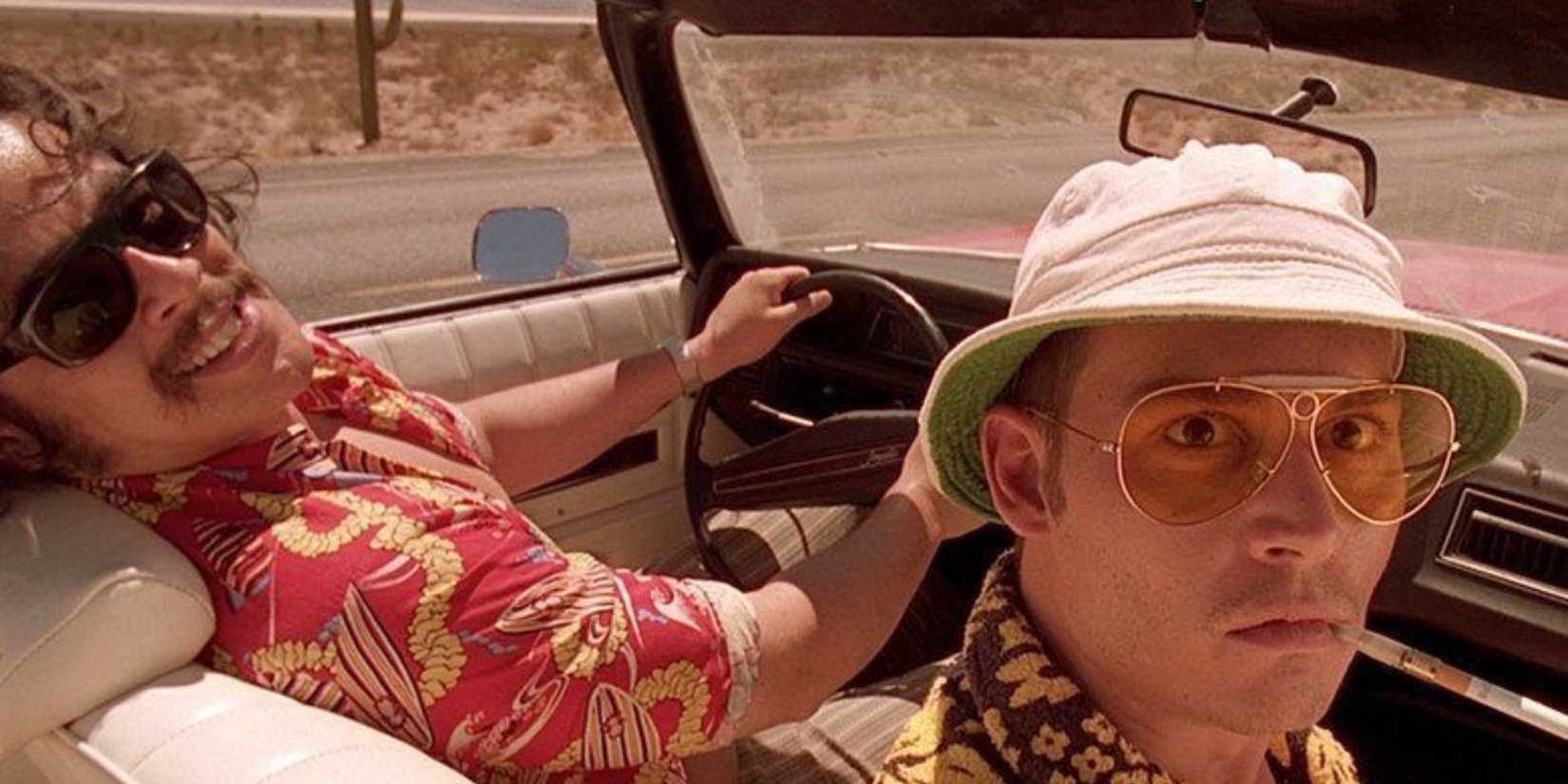 Two men in the front seat of a car looking back at the camera in Fear and Loathing in Las Vegas’ (1998)