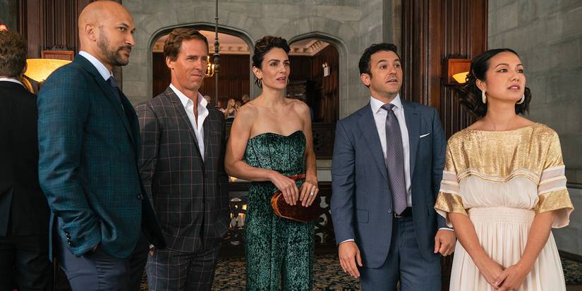 Five friends from Friends from College all dressed up, looking over at something or someone.