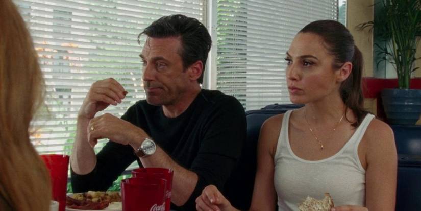Gal Gadot and Jon Hamm look frustrated during an argument in a diner in Keeping Up With the Joneses