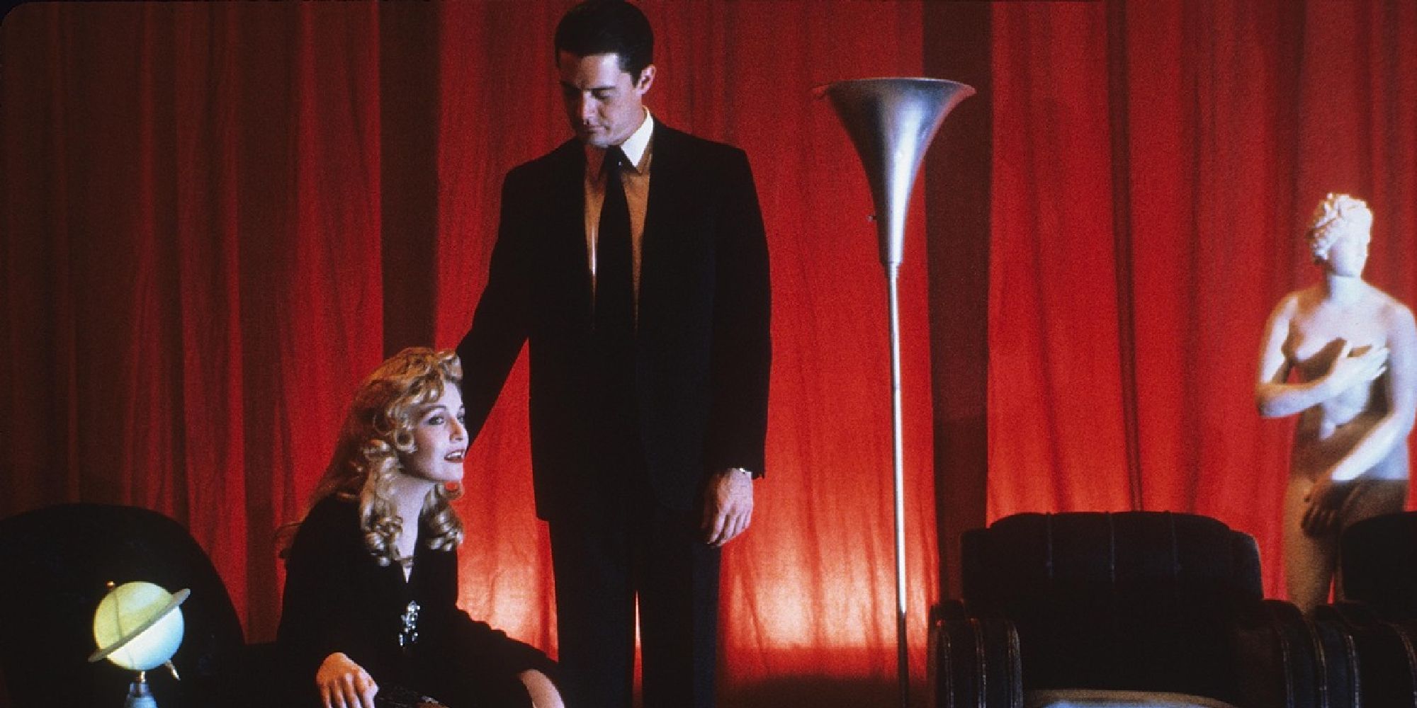 Dale Cooper looks as a distressed Laura Palmer eatches a TV in Twin Peaks: Fire Walk with Me