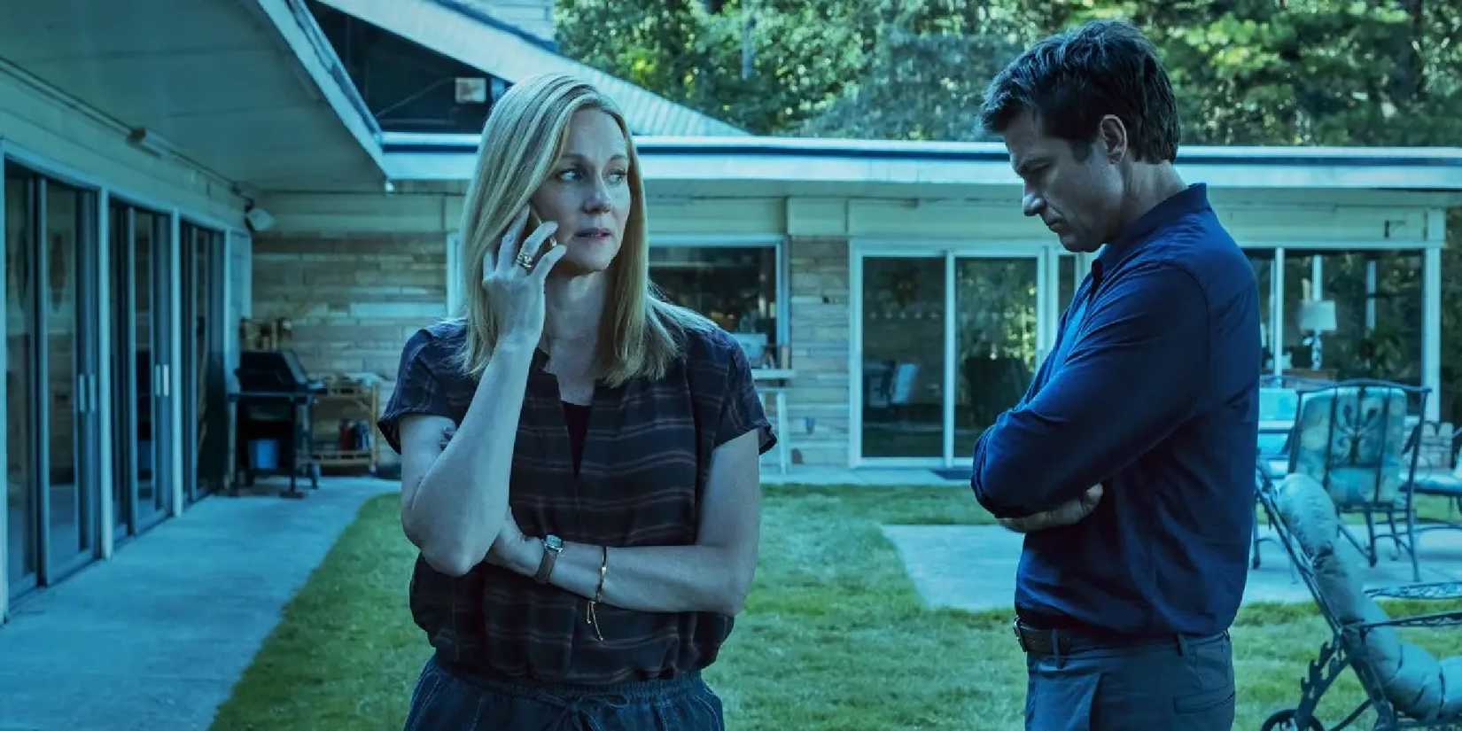 Laura Linney on a mobile phone and Jason Bateman standing near in a yard in Ozark.