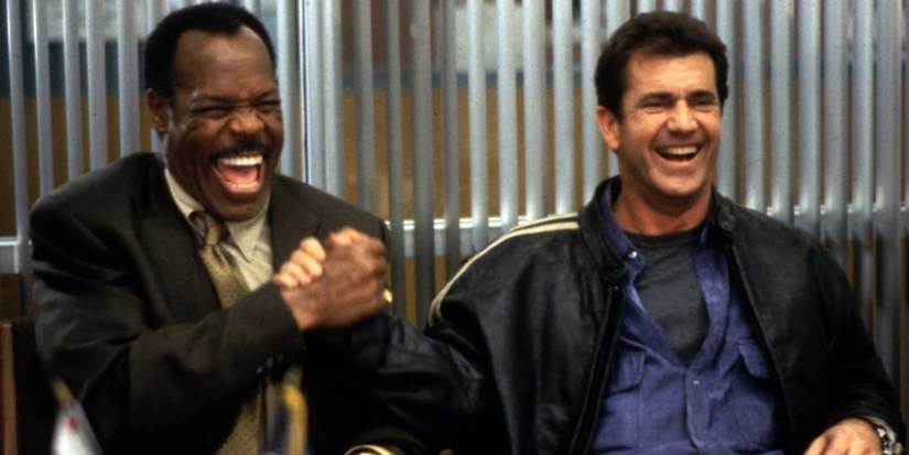 Roger and Martin laughing and shaking hands in Lethal Weapon 4