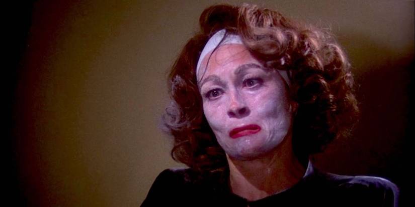 Faye Dunaway as Joan Crawford with cream on her face crying in Mommie Dearest