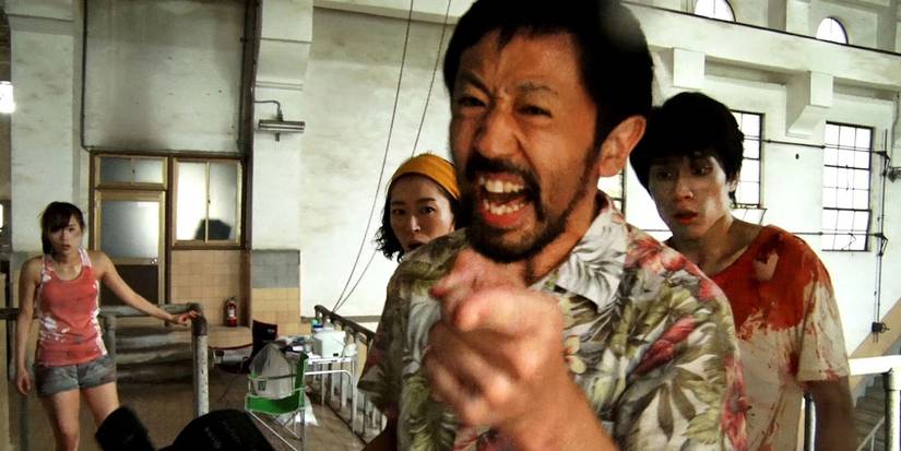 A man laughing and pointing at the camera in One Cut of the Dead 2017 