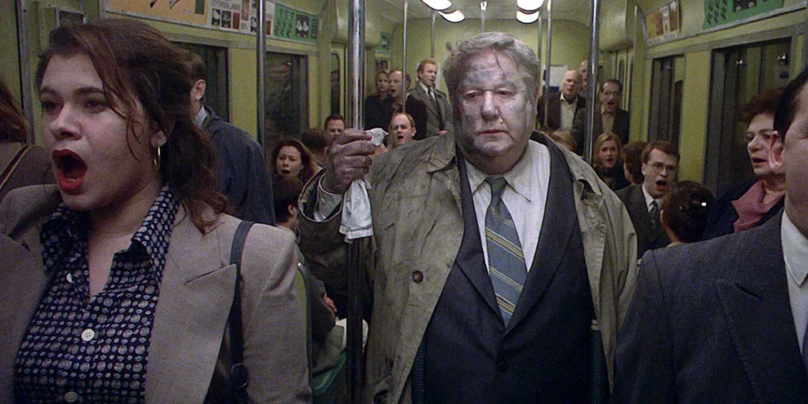 A dirty man in the subway surrounded by people in Songs from the Second Floor - 2000-1