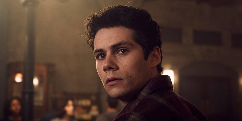 Dylan O'Brien as Stiles looking over his shoulder dramatically in Teen Wolf.