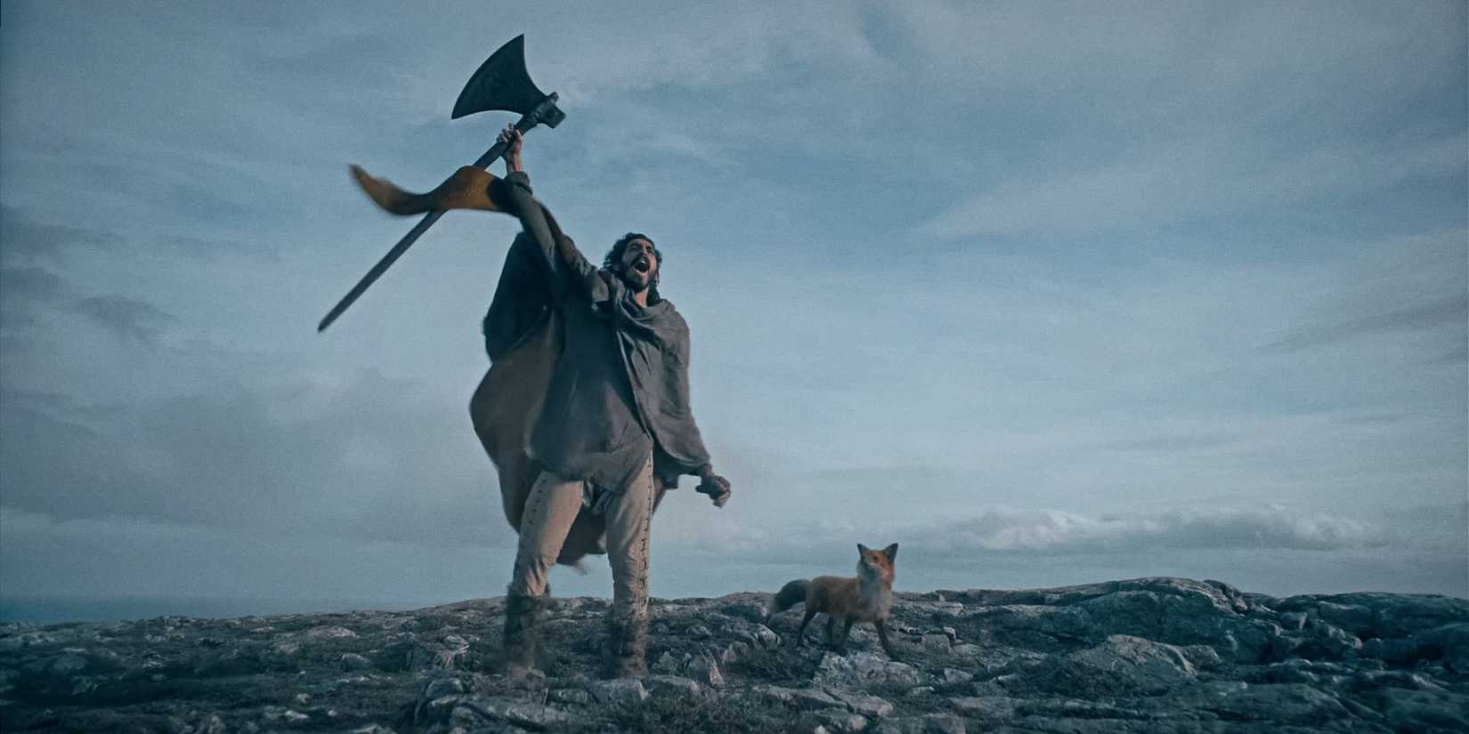 Sir Gawain lifting his axe to the sky in The Green Knight (2021)