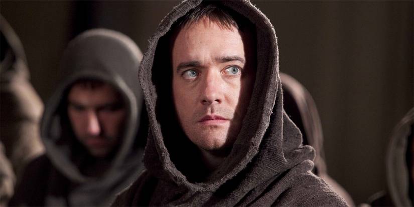 Matthew Macfadyen in a monk's robe with other monks behind him in The Pillars of the Earth.