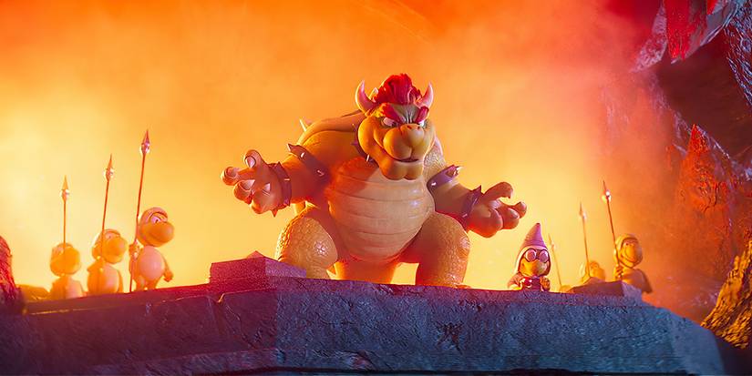 Bowser (voiced by Jack Black) standing in front of a fiery background and his army of koopas in The Super Mario Bros. Movie.
