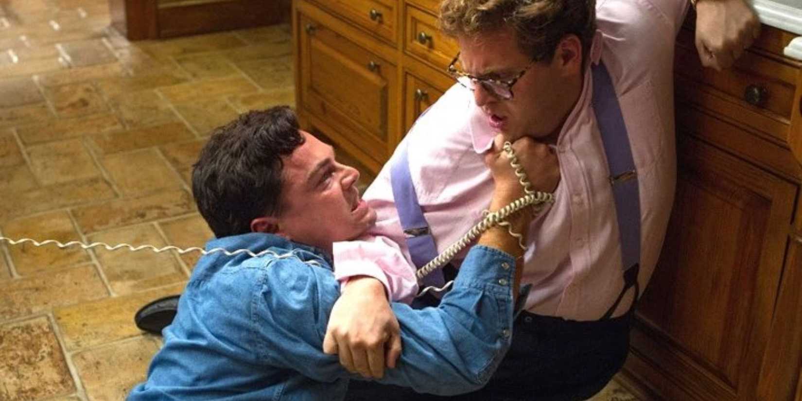Jordan Belfort (Leonardo DiCaprio) and Donnie Azoff (Jonah Hill) struggle in The Wolf of Wall Street.