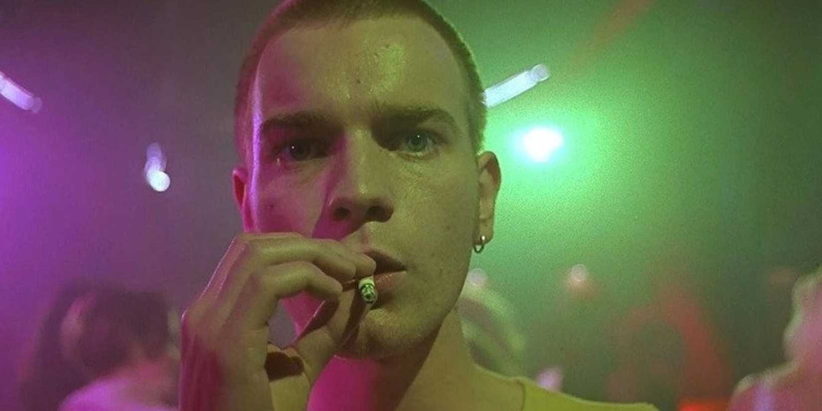 Ewan McGregor as Mark Renton, smoking a cigarette at a nightclub in 'Trainspotting'.