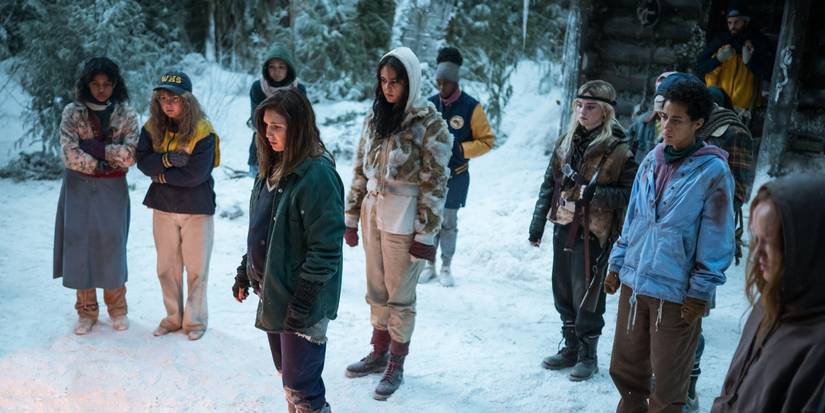 Cast members of the 90s timeline featuring the teenage versions of characters out in the snow in Yellowjackets Season 2