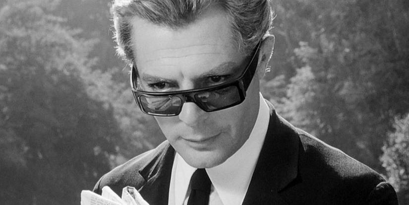 Italian filmmaker Guido Anselmi (Marcello Mastroianni) drifts off while reading the newspaper in '8 1/2'.