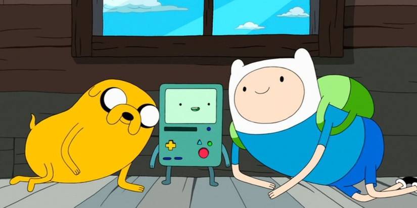 Jake, BMO, and Finn sitting together in their tree house in Adventure Time.
