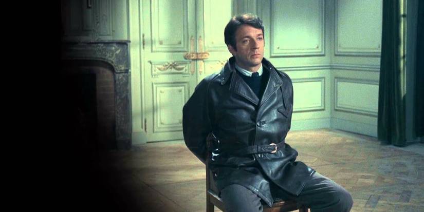Jean-Pierre Cassel in a chair in Army of Shadows