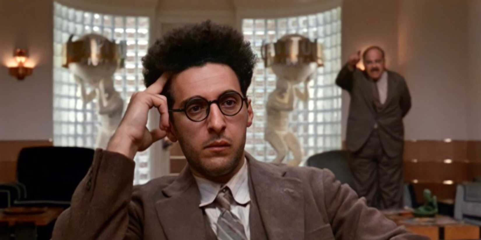 Barton Fink (John Turturro) looking pensive and annoyed in Barton Fink.