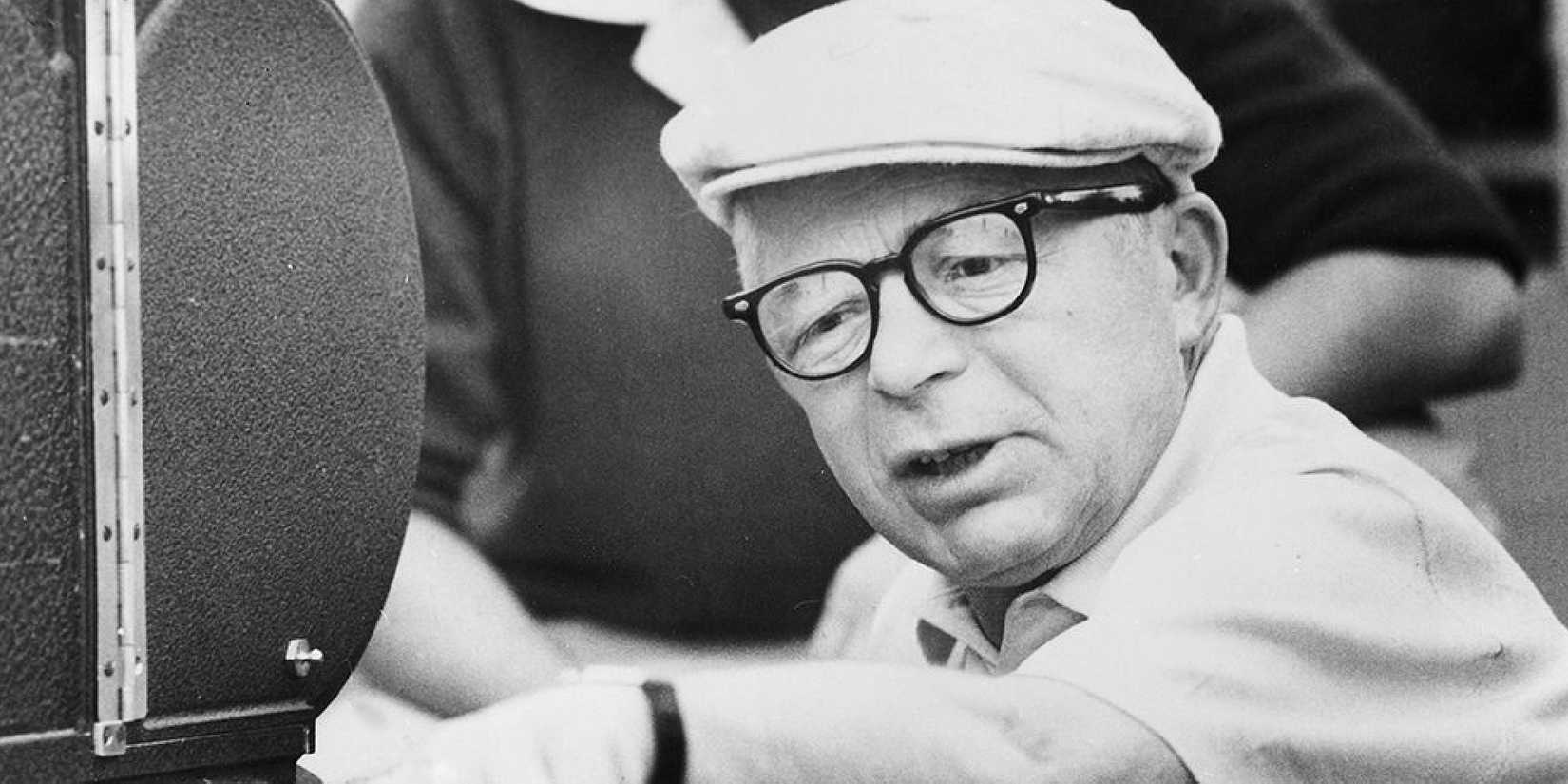 Billy Wilder beside a camera directing a film.