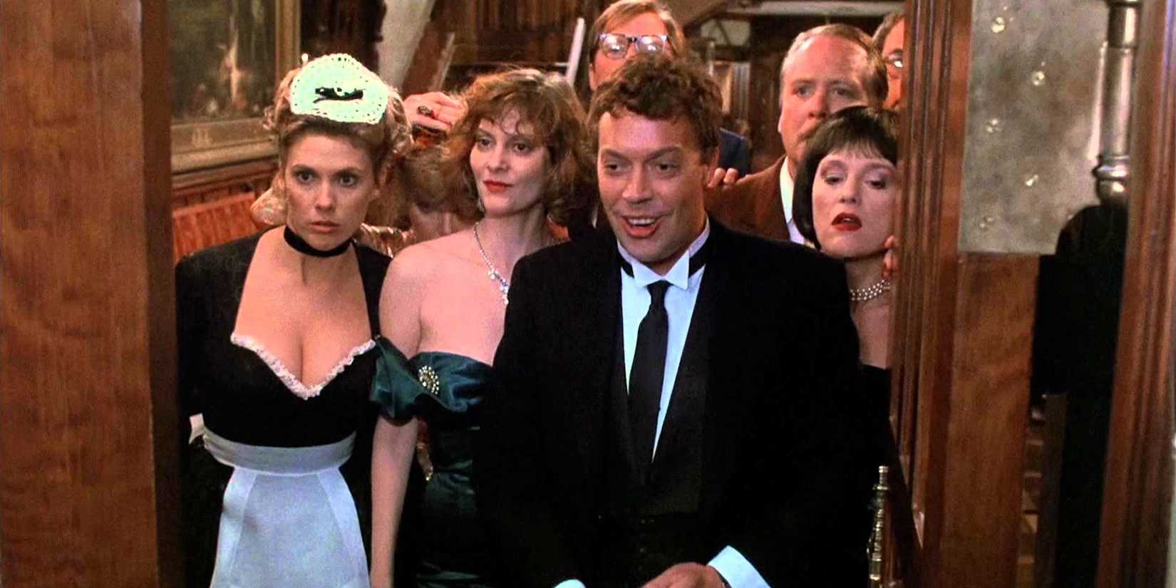 The cast of Clue looking out an open door.
