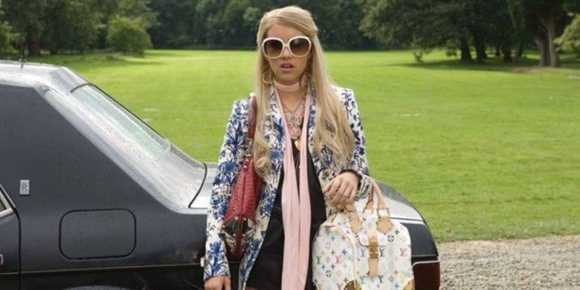 Emma Roberts as Poppy Moore standing in front of a car in Wild Child