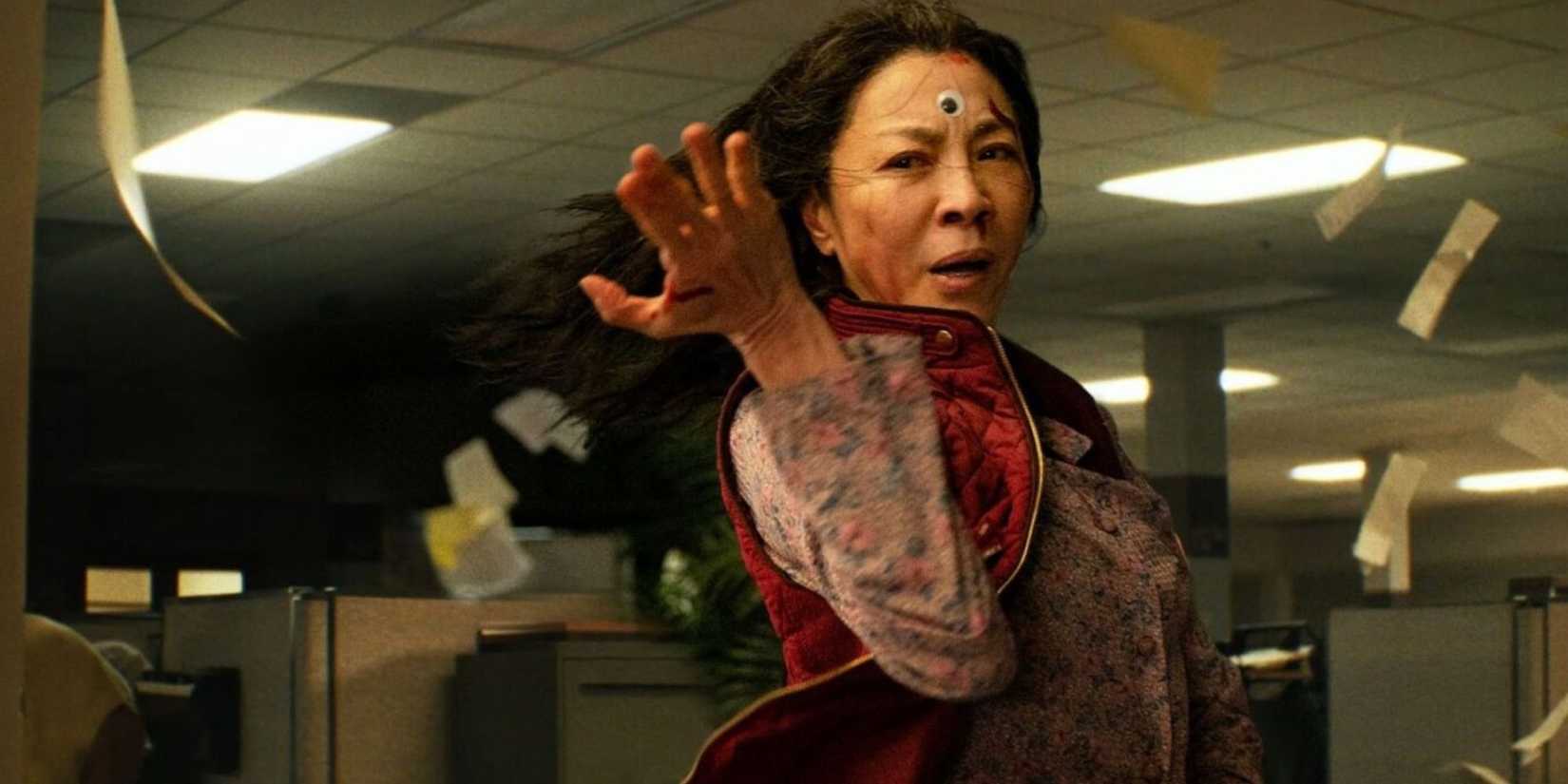 Evelyn, fighting while paper sheets fly around her in Everything Everywhere All at Once