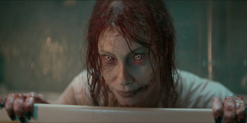 Deadite Ellie (Alyssa Sutherland) clutching on to the bathtub in Evil Dead Rise.