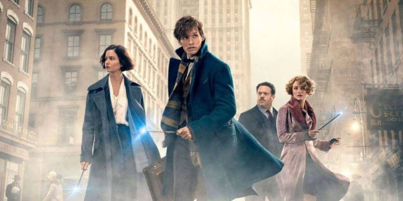 The four main characters from Fantastic Beasts and Where to Find Them posing surrounded by fog in a London city.