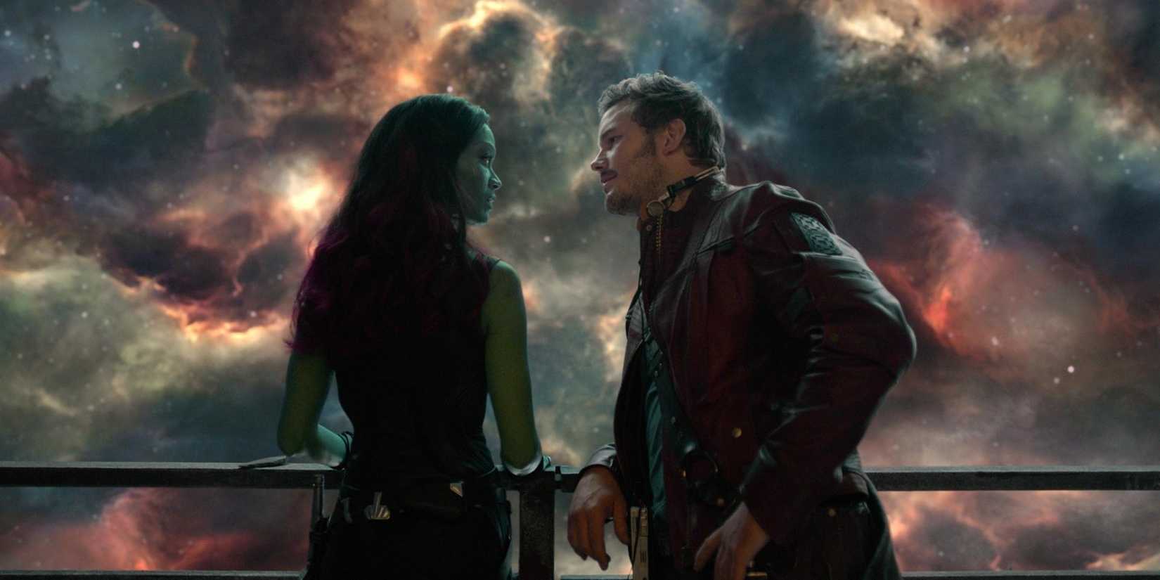Gamora and Peter Quill lean against a railing in Guardians Of The Galaxy.