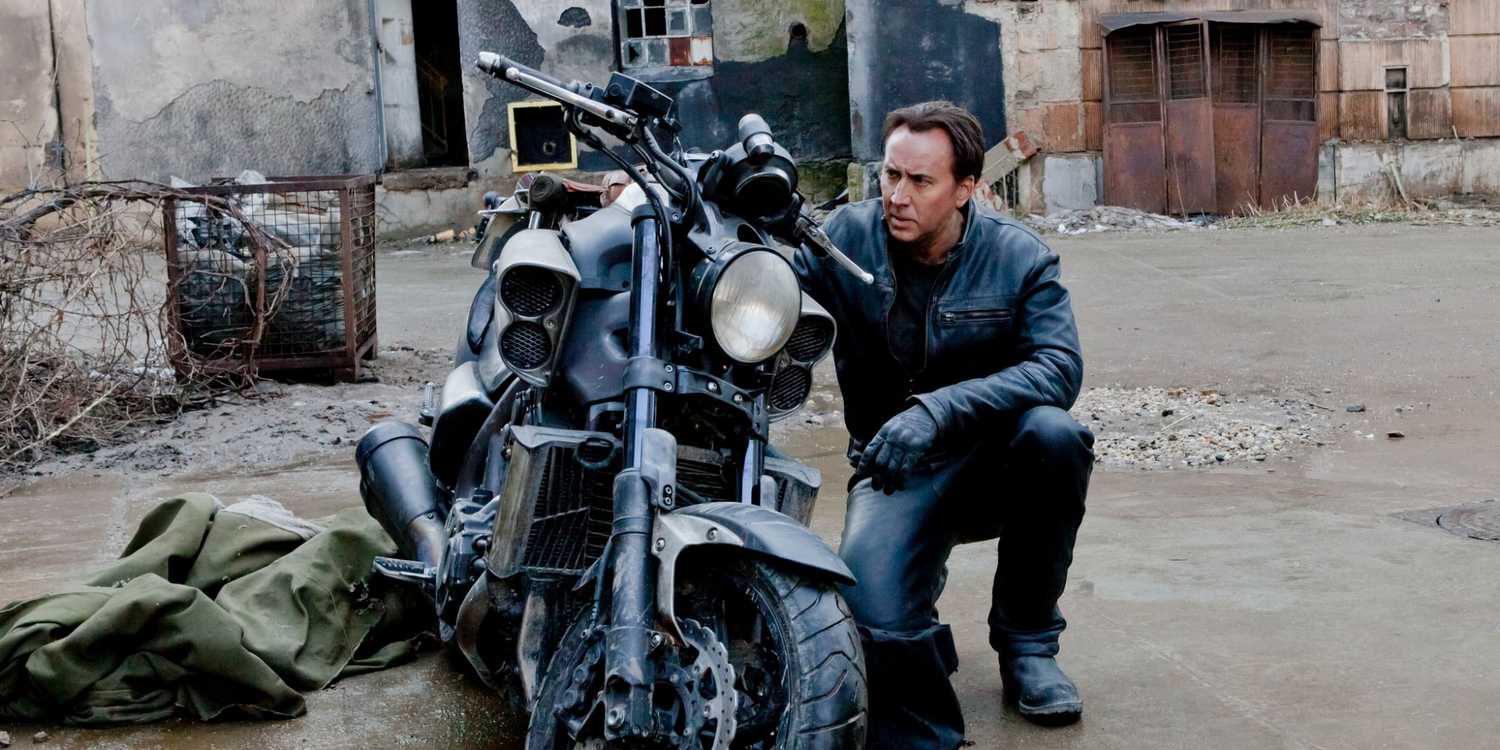 Nic Cage kneeling by a motorcycle in Ghost Rider: Spirit of Vengeance