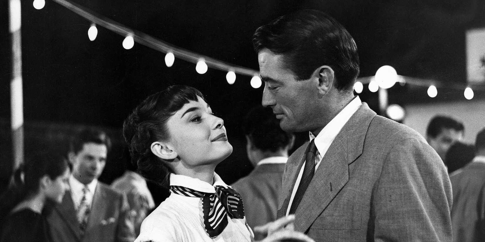 Audrey Hepburn and Gregory Peck as Princess Ann and Joe looking at each other while dancing in Roman Holiday